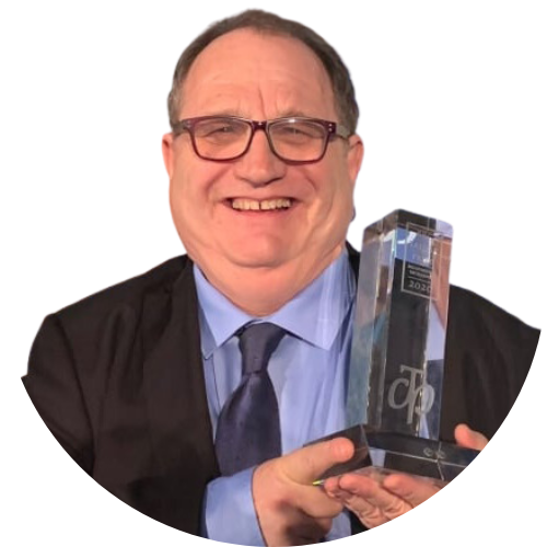 A portrait of Dr Mark Bourrie holding and award