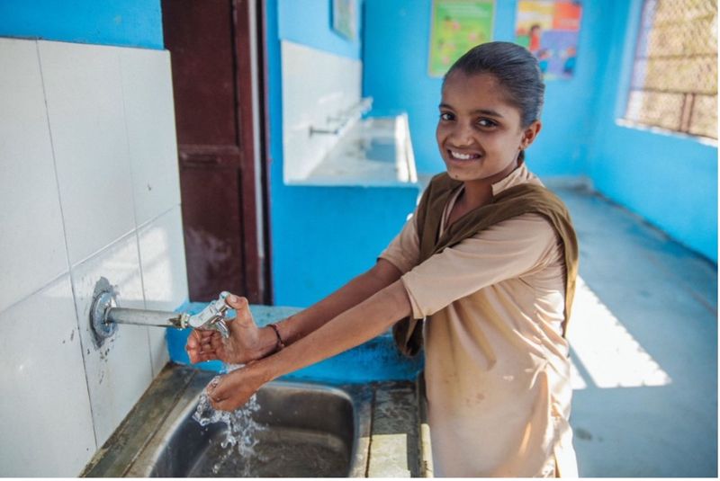 a young women washing her hands
