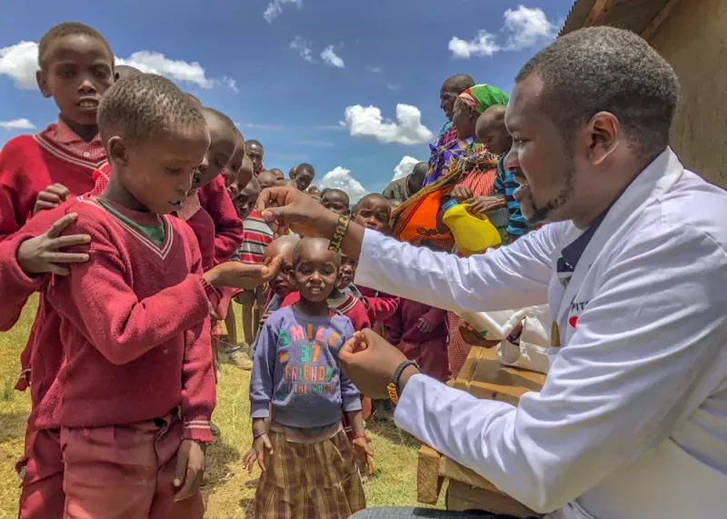 A doctor helping some young children